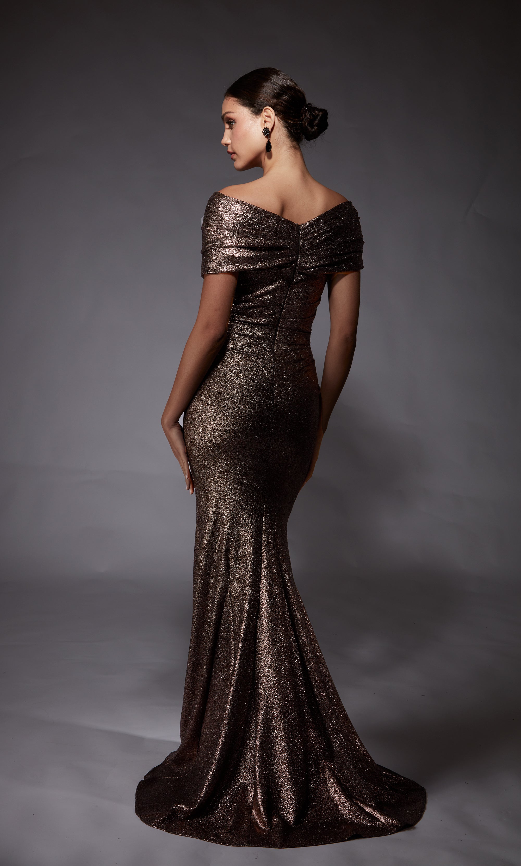 Off the shoulder draped formal dress with a fit and flare silhouette in a metallic cocoa color.