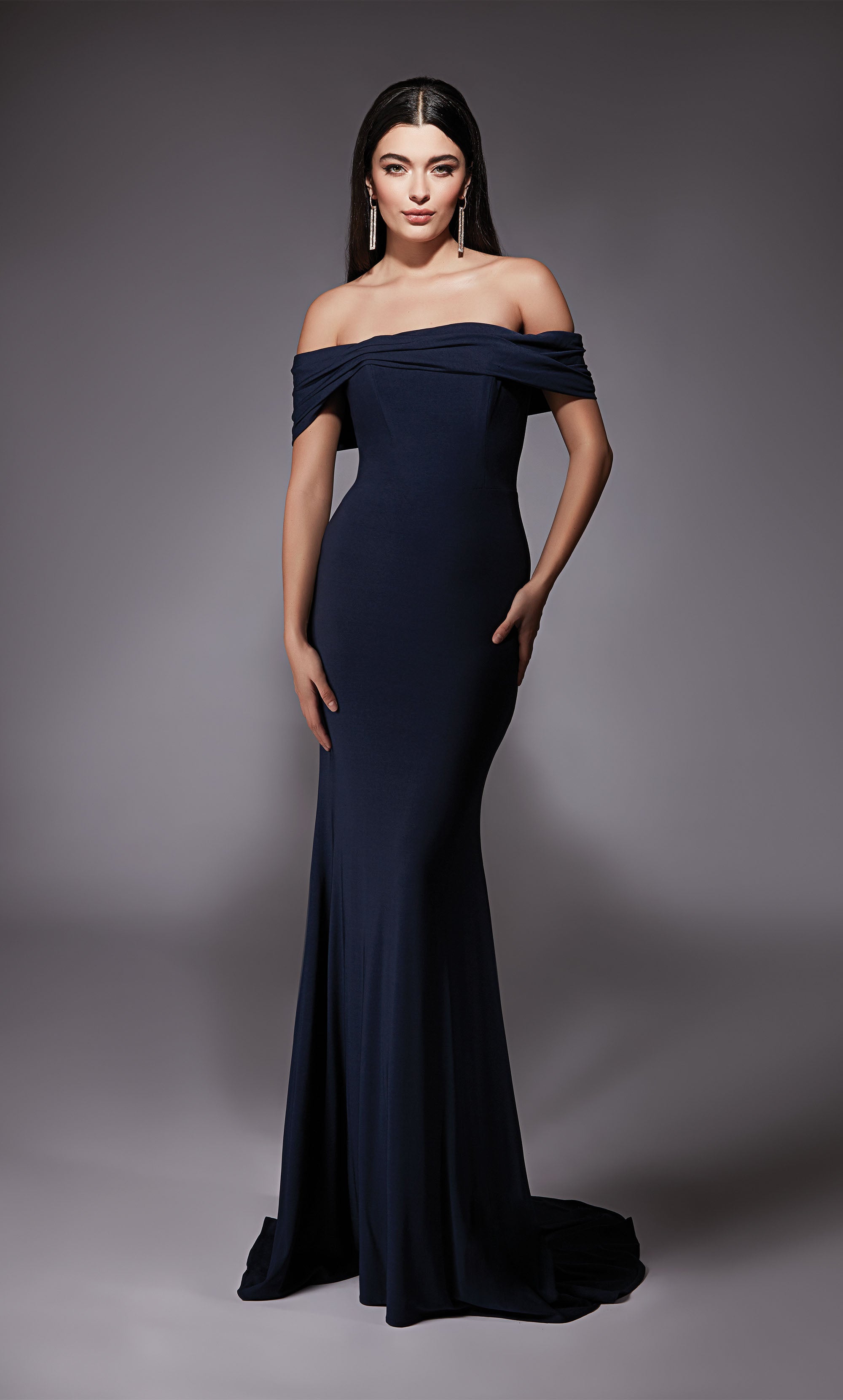 A navy evening gown with an off the shoulder neckline and fit an flare silhouette. The dress was crafted from a gorgeous Italian Jersey fabric.