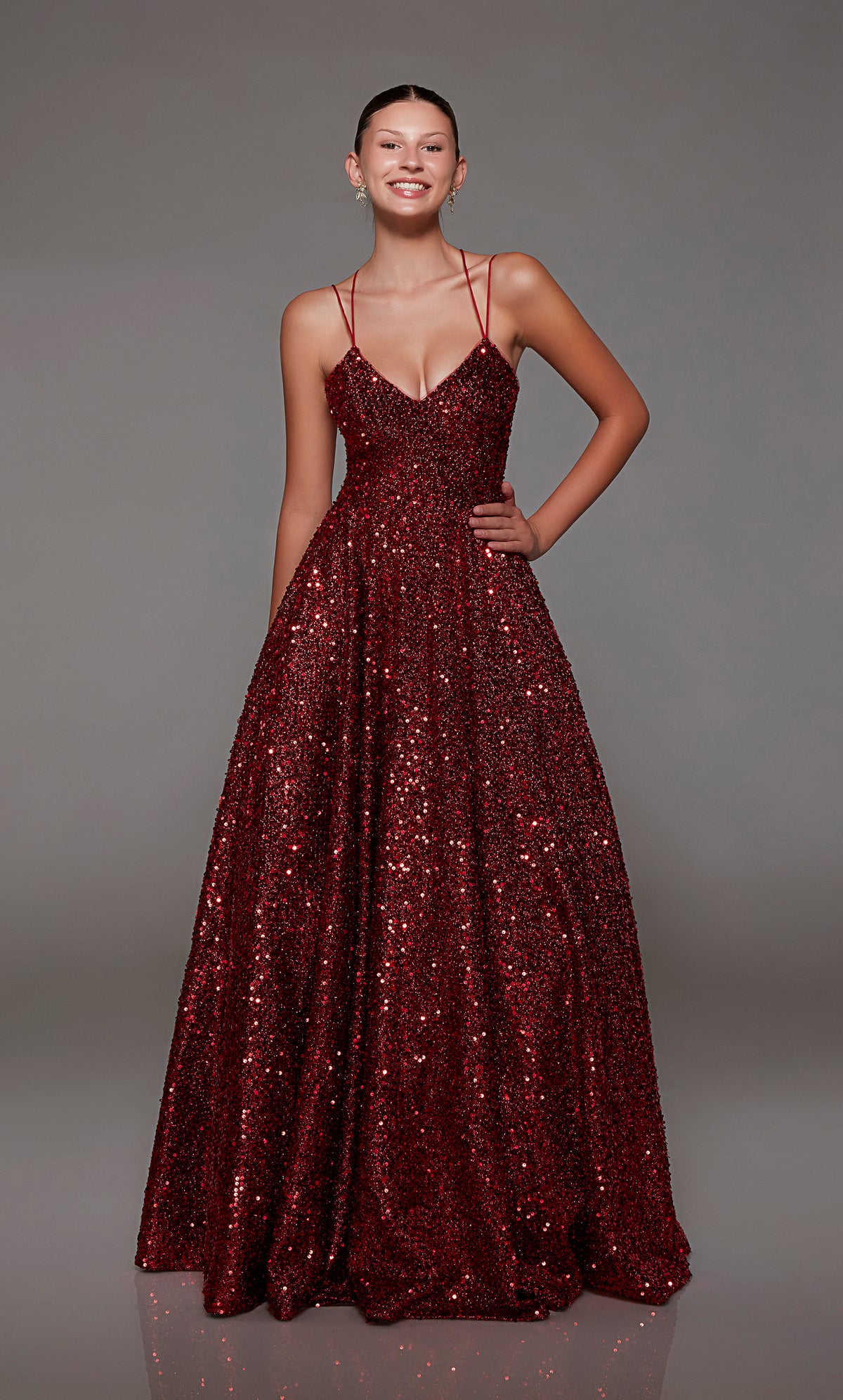 Elegant red A-line prom dress with an V-neck, adorned with sequins, dual straps, and an charming lace-up back.