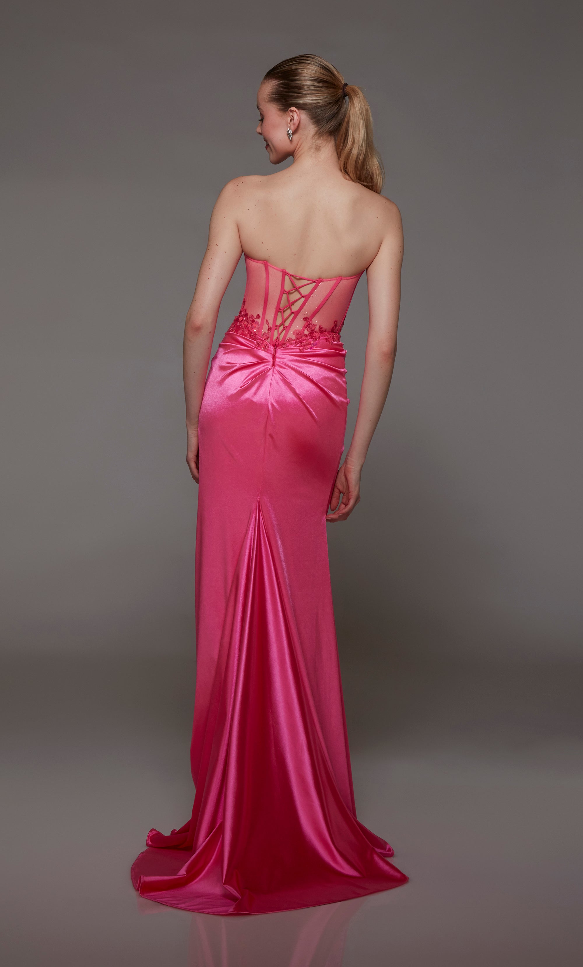 Neon pink corset prom dress: sheer bodice, ruching, high slit, lace-up back, train. Stretch satin with beaded lace accents for an dazzling look.