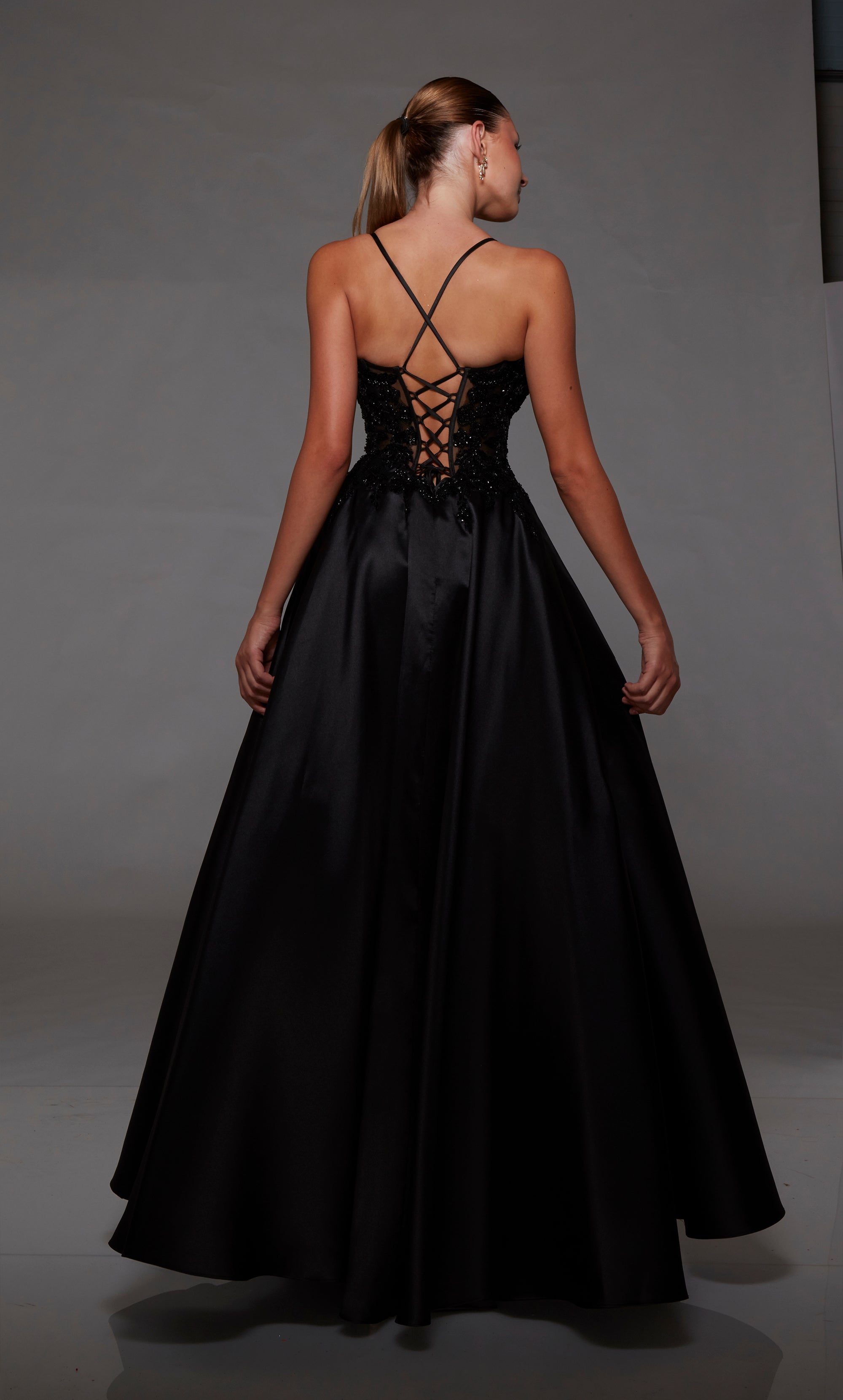 Black corset ball gown: V-neckline, sheer floral lace bodice, full mikado skirt, lace-up back for an captivating and timeless look.