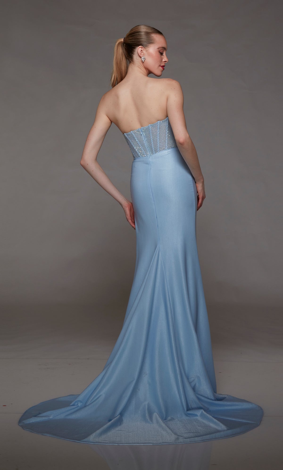 Glacier blue strapless prom dress: Shimmery hotfix rhinestone-adorned corset top, metallic stretch jersey skirt with daring side slit and train, zip-up back for an glamorous look.