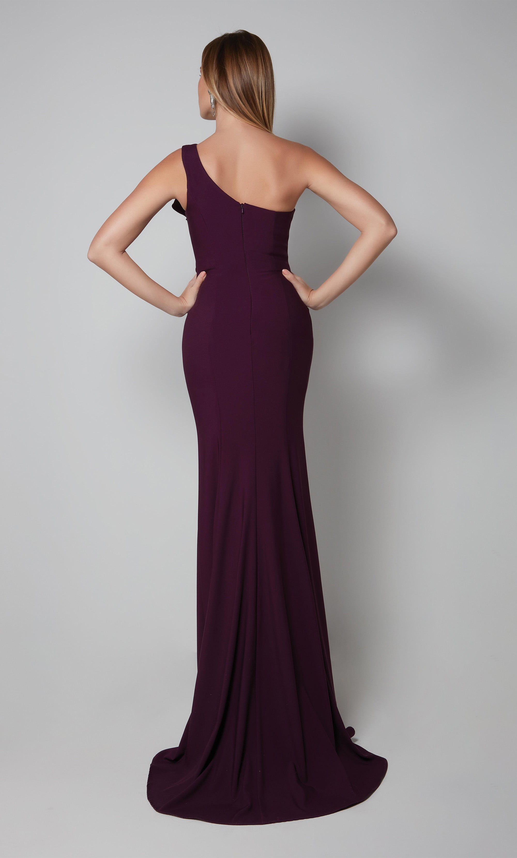 Long one shoulder ruffle dress with a side slit in purple.