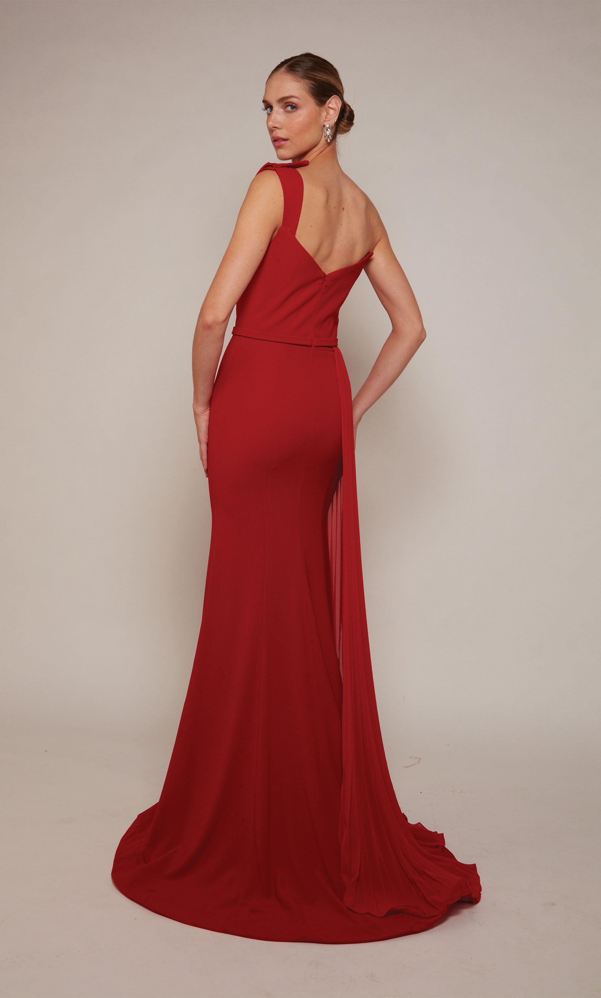 A long formal dress with a one shoulder neckline and side slit in a vibrant red.