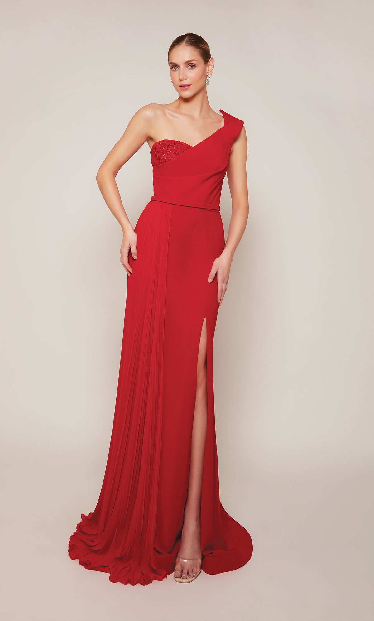 A long formal dress with a one shoulder neckline and side slit in a vibrant red.