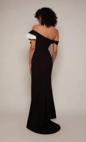 A black and white evening gown with an off-the-shoulder neckline and ruffle bodice. In addition, the dress has a faux belt at the waistline and a slight train.