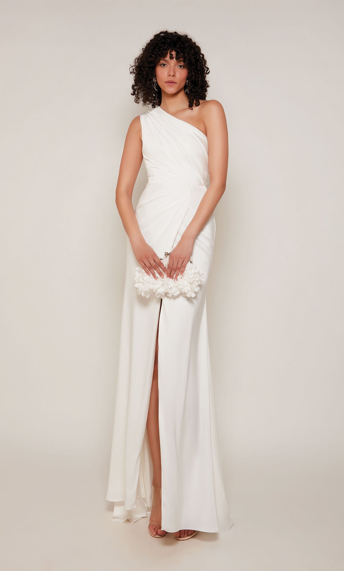 An elegant, satin one shoulder gown with ruching detail and front slit, in the color diamond white.