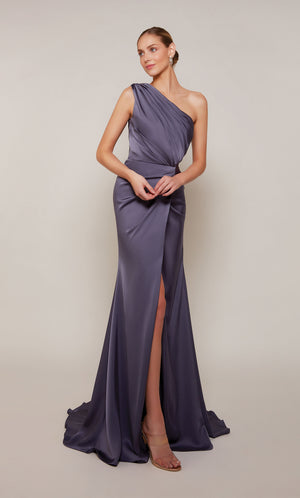 An elegant, satin one shoulder gown with ruching detail and front slit, in a purple-ish grey color called storm cloud.