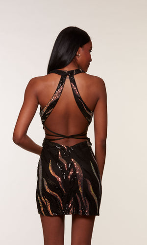 A black and gold sequin embellished short formal dress, highlighting a plunging halter neckline and strappy back.