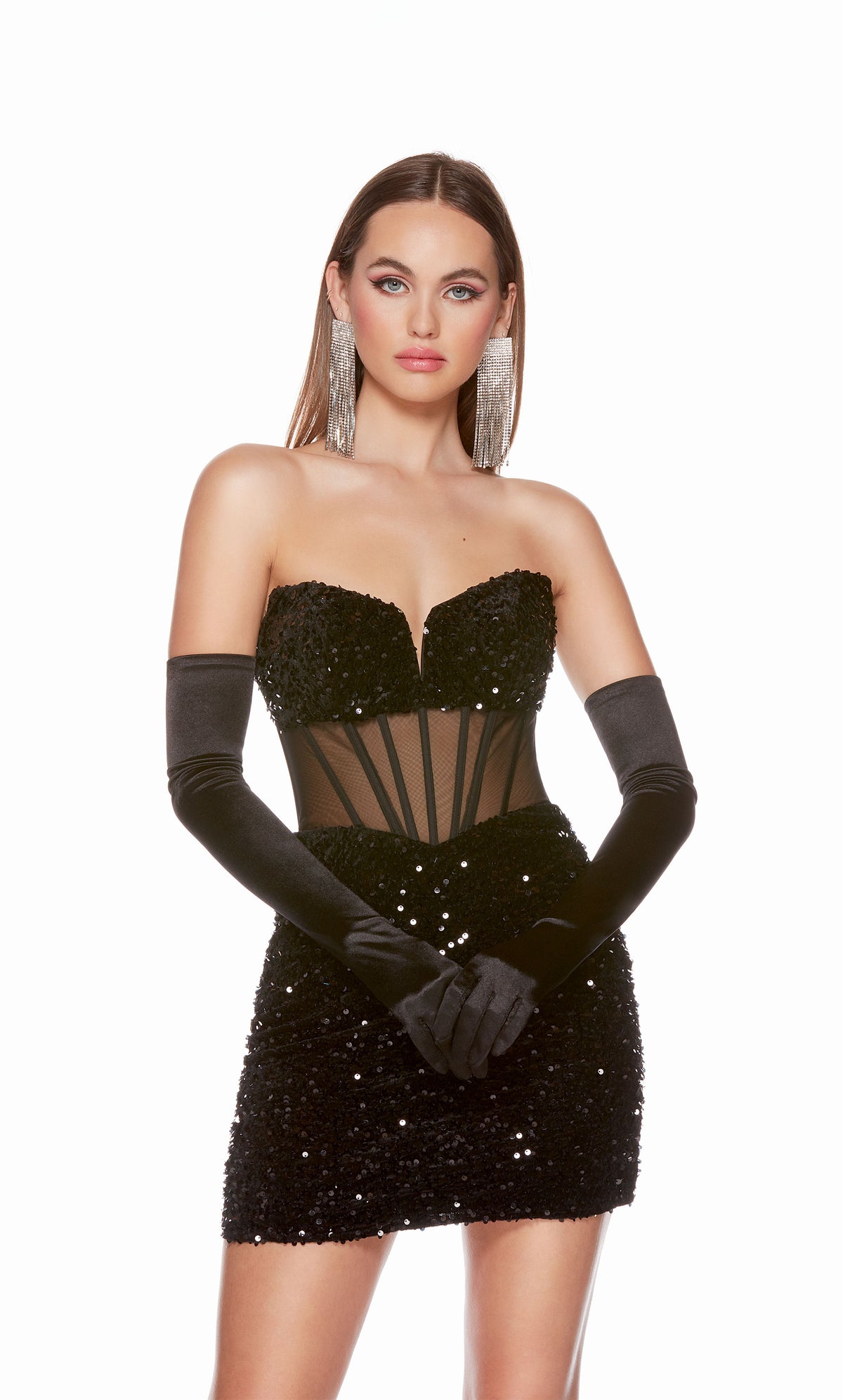 A glamorous corset top dress featuring a strapless sweetheart neckline and sheer bodice, in black plush sequins. The dress was accessorized with long black satin gloves which are not included with dress purchase.