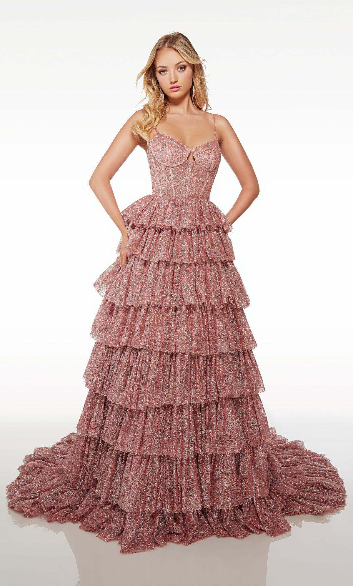 Gorgeous pink glitter tulle ball gown featuring an modified sweetheart neckline, corset bodice, and an ruffled skirt with an long, elegant train.