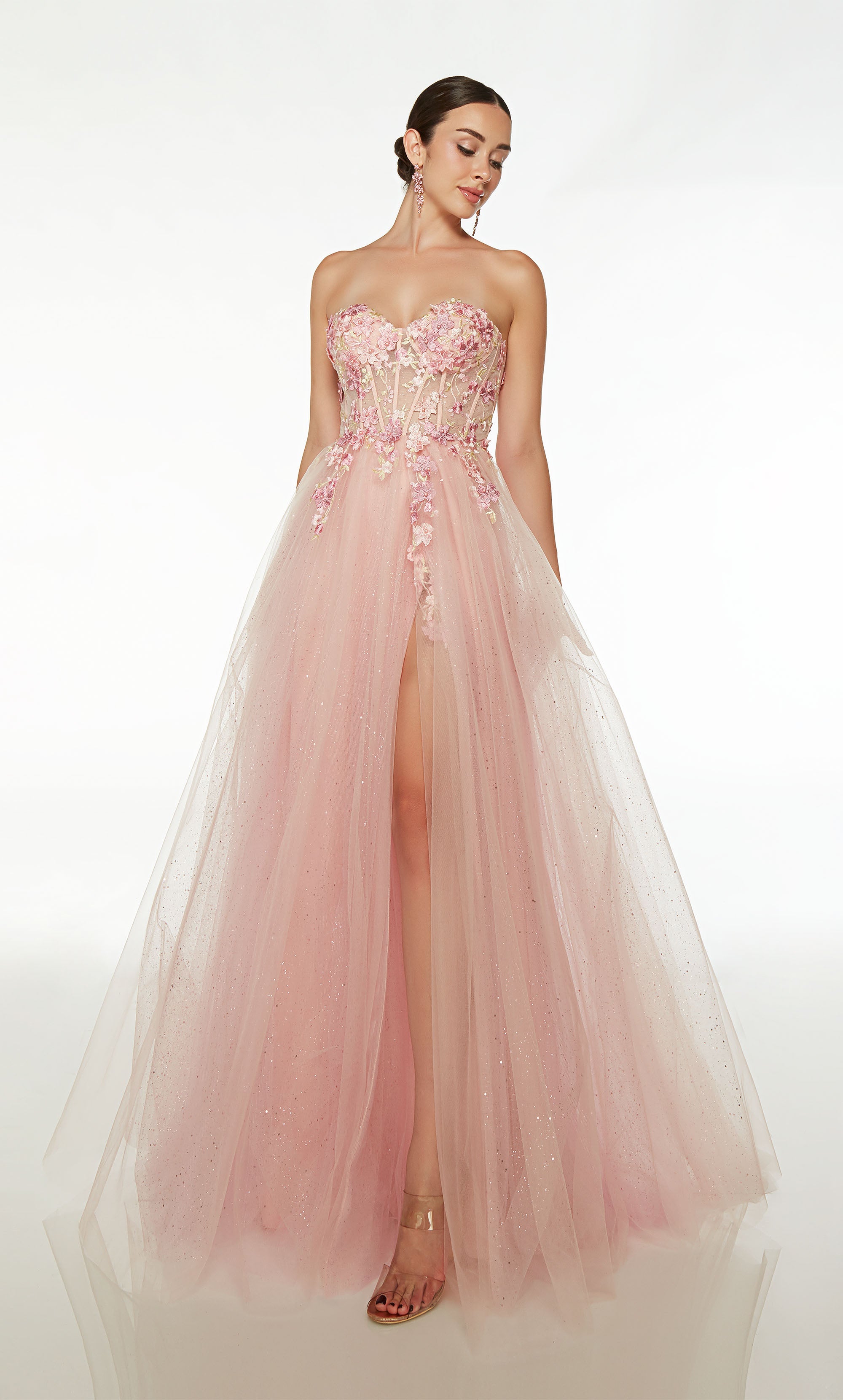 Ultra-feminine light pink prom dress: sheer strapless corset top, floral lace appliques, front slit, lace-up back, and glitter tulle train for an glamorous look.