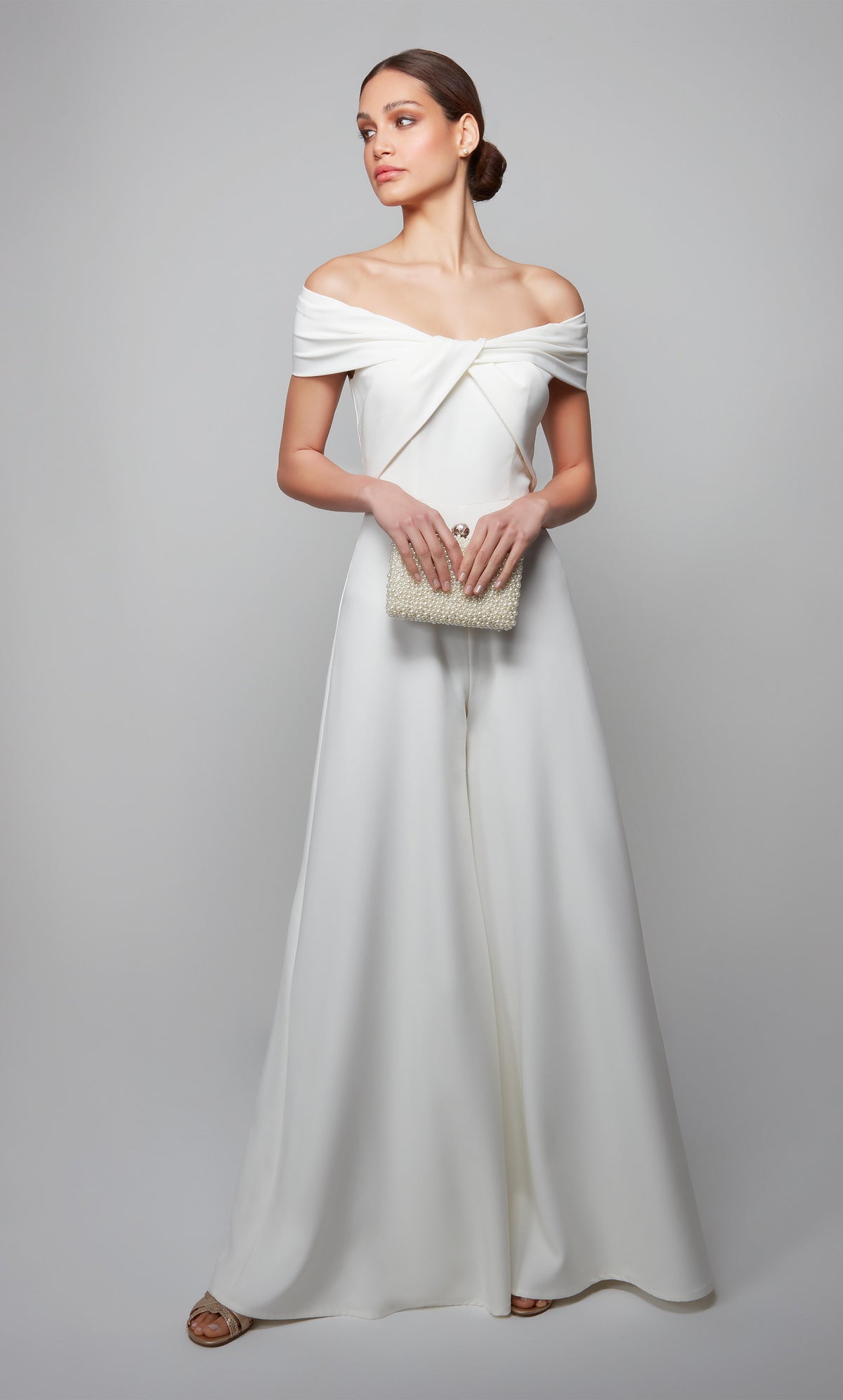 Ivory wedding reception jumpsuit with an off the shoulder neckline.