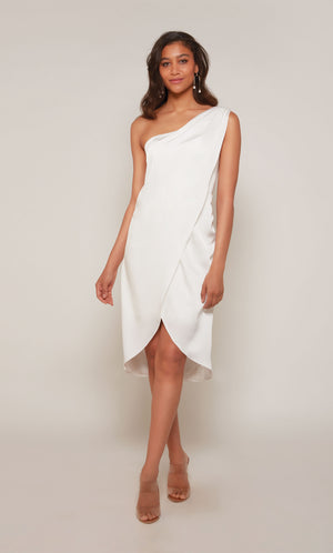 A satin wedding dress with a one shoulder neckline and an asymmetrical hemline in diamond white.