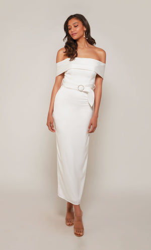 A  white, satin midi dress with an off the shoulder neckline and thick belt at the waistline. The skirt is a fitted pencil skirt with a back slit.