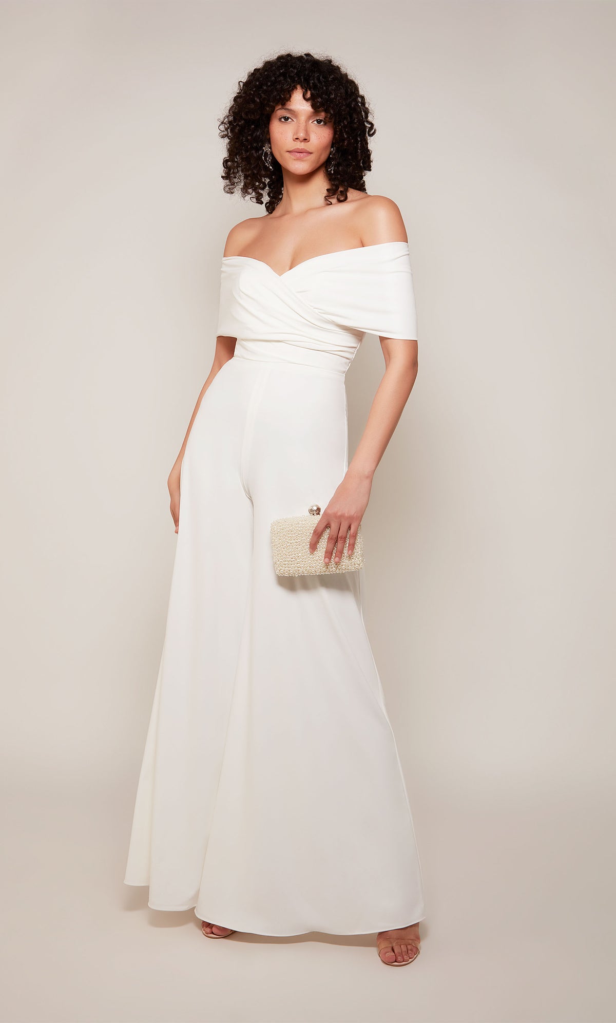 An off-the-shoulder jumpsuit with a wide fit and flare pant in diamond white.