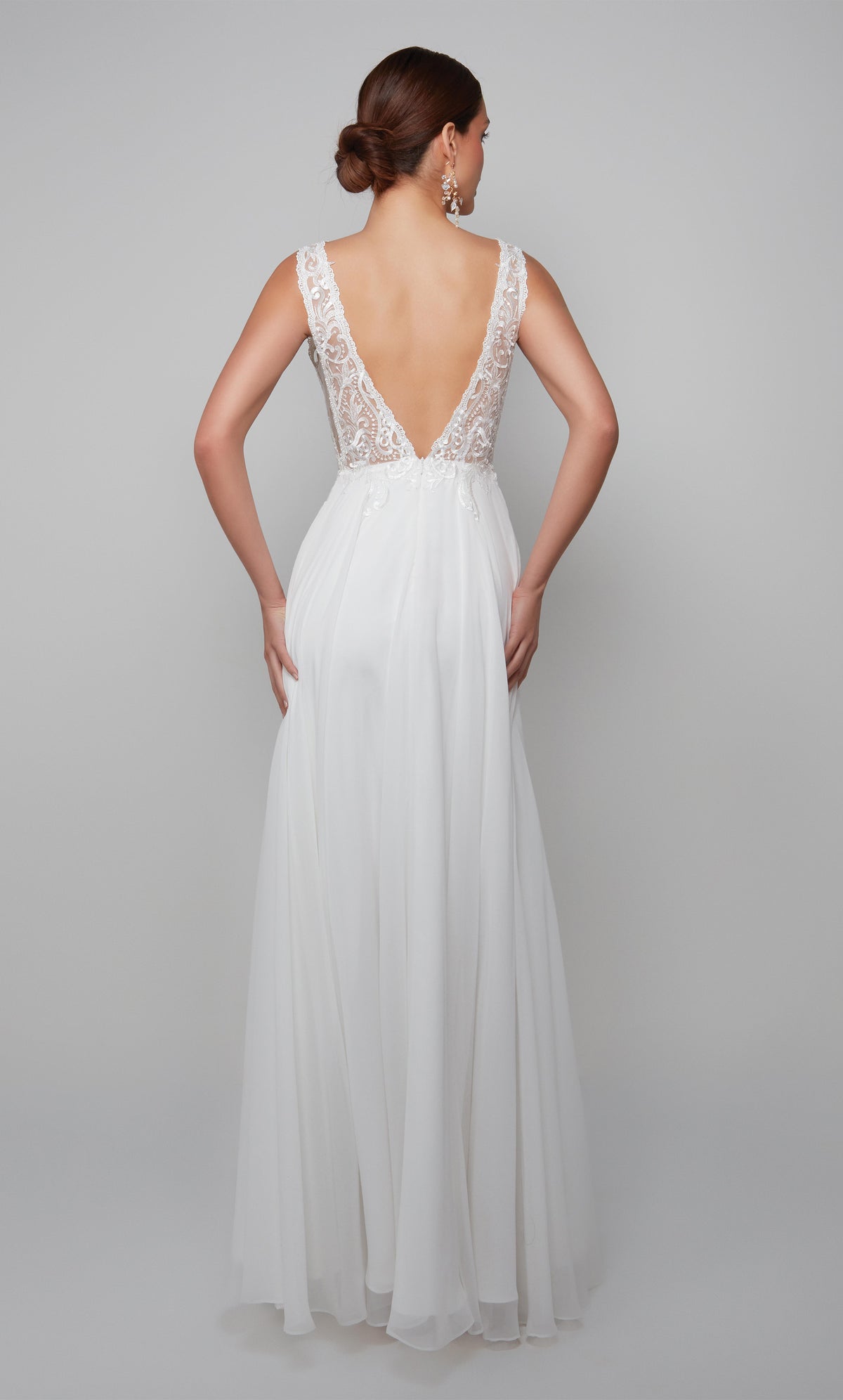 Plunging boho wedding dress with an elegant lace bodice, deep V back style, and flowy chiffon skirt in white.