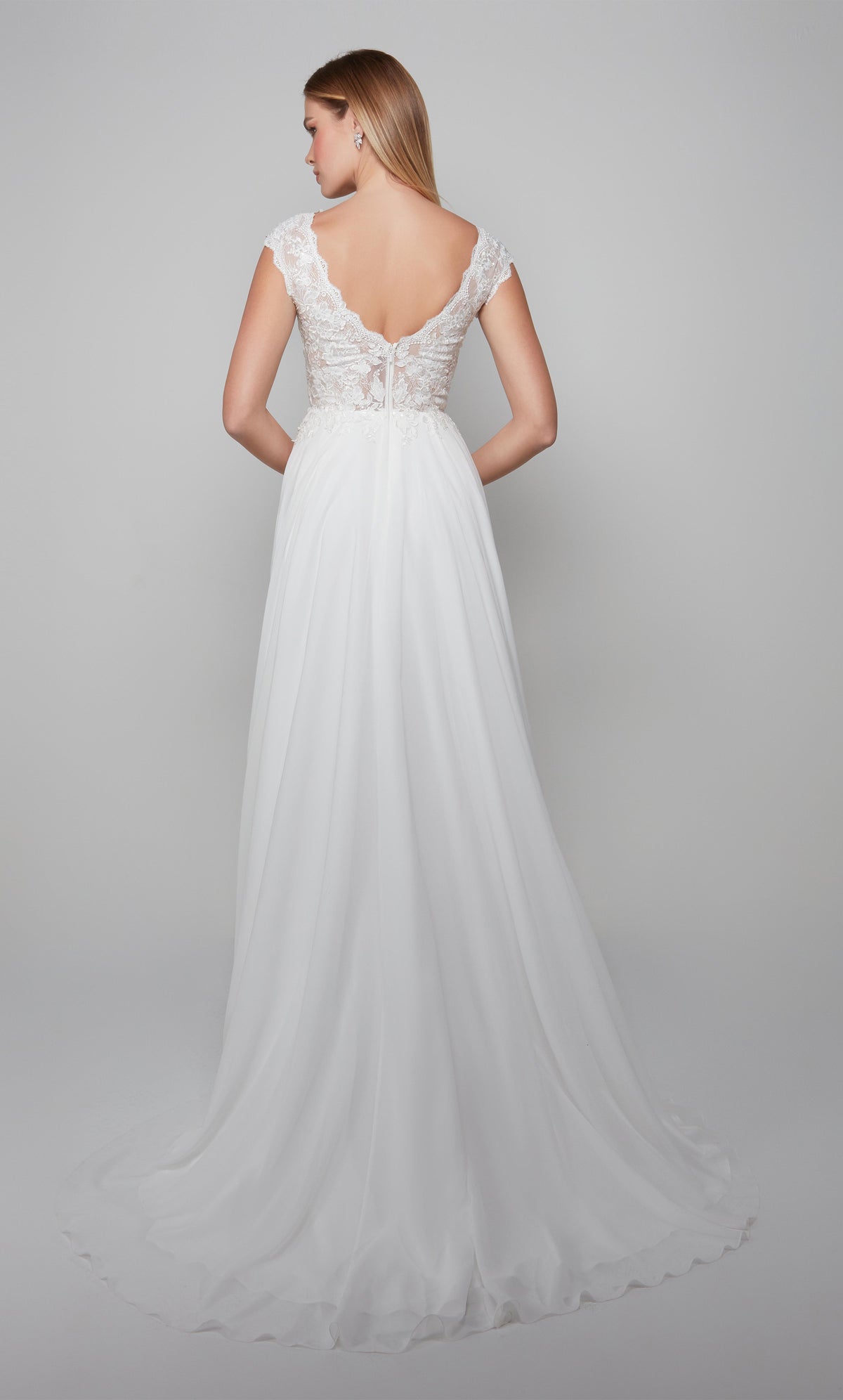 Flowy chiffon wedding gown with a lace bodice, V shaped back, and train in diamond white.