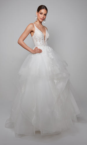 Plunging corset wedding dress with a lace bodice and tiered tulle skirt in ivory.