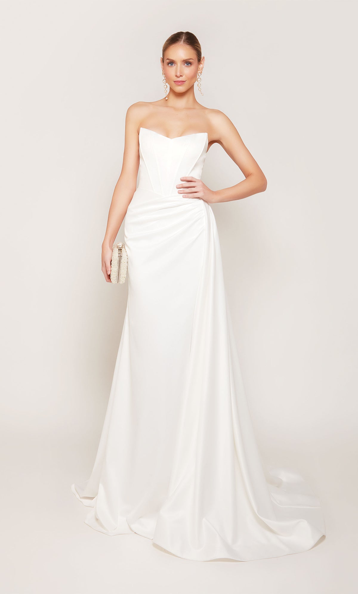 A strapless, corset wedding dress with a ruched waist, an elegant side slit, and detachable side train for a dramatic effect.