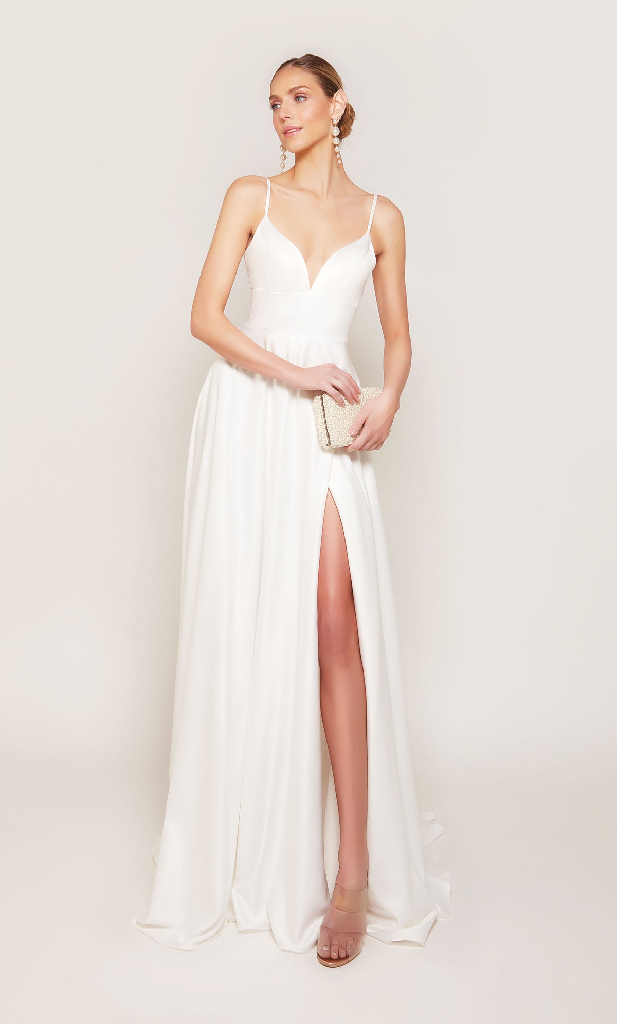 A simple, satin wedding dress with a V-neckline, side slit, and pockets. 