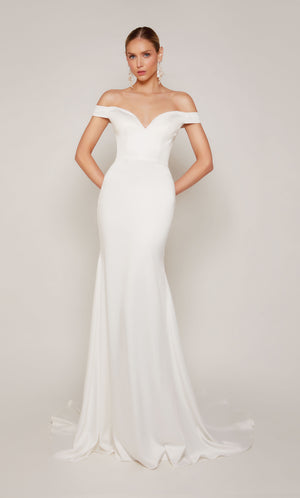 A sophisticated, off-the-shoulder satin wedding dress with a detachable train and satin-covered buttons 