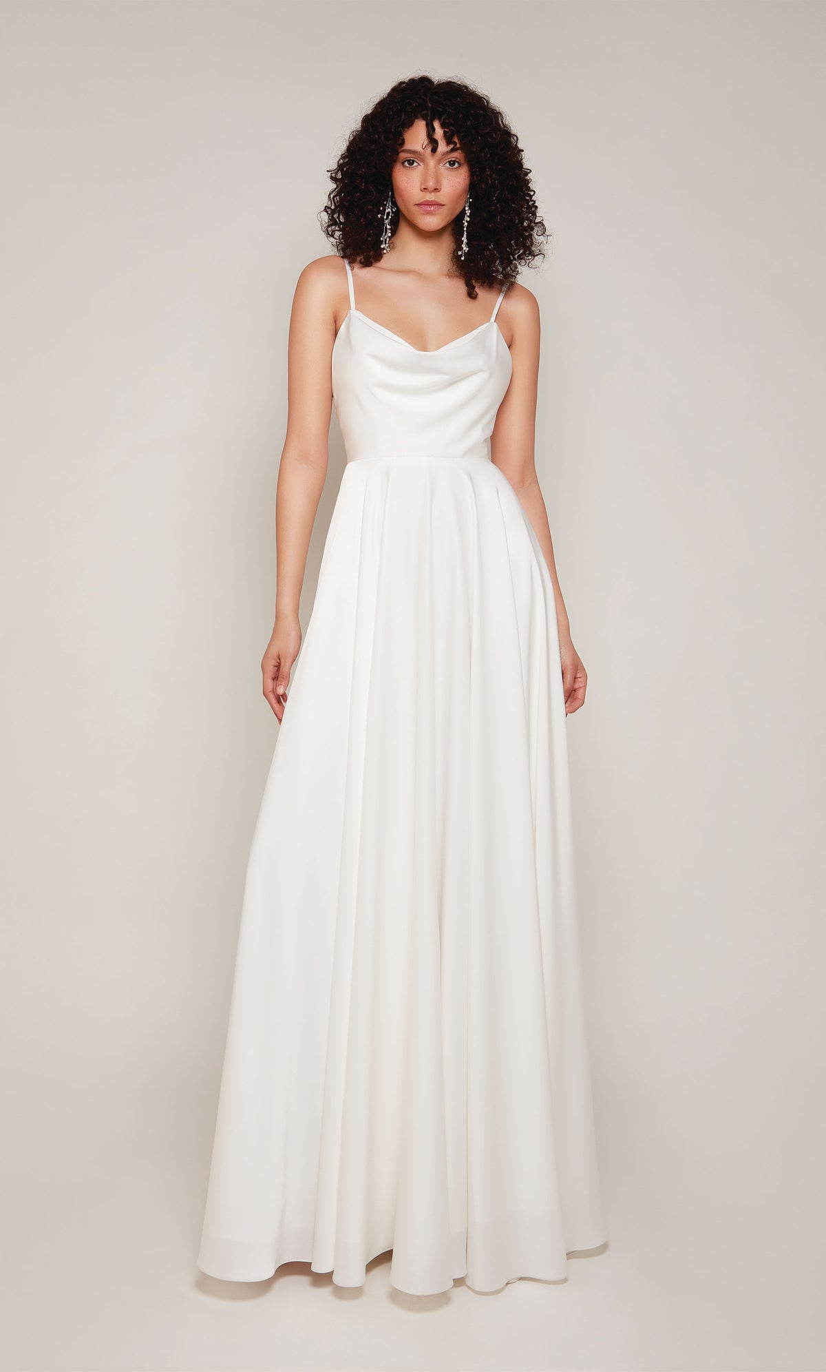 A simple wedding dress in white satin with an A-line skirt, V-shaped cowl neckline, and adjustable spaghetti straps.