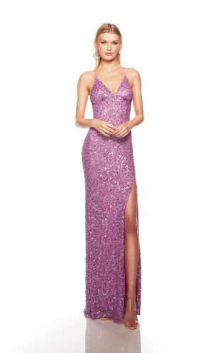 Purple sequin gown with an V neckline, slit, and crisscross adjustable strap back, and an slight train for an elegant and alluring look.