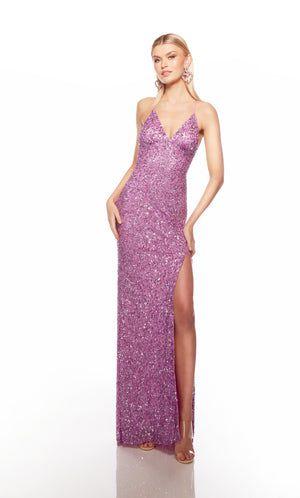 Purple sequin gown with an V neckline, slit, and crisscross adjustable strap back, and an slight train for an elegant and alluring look.